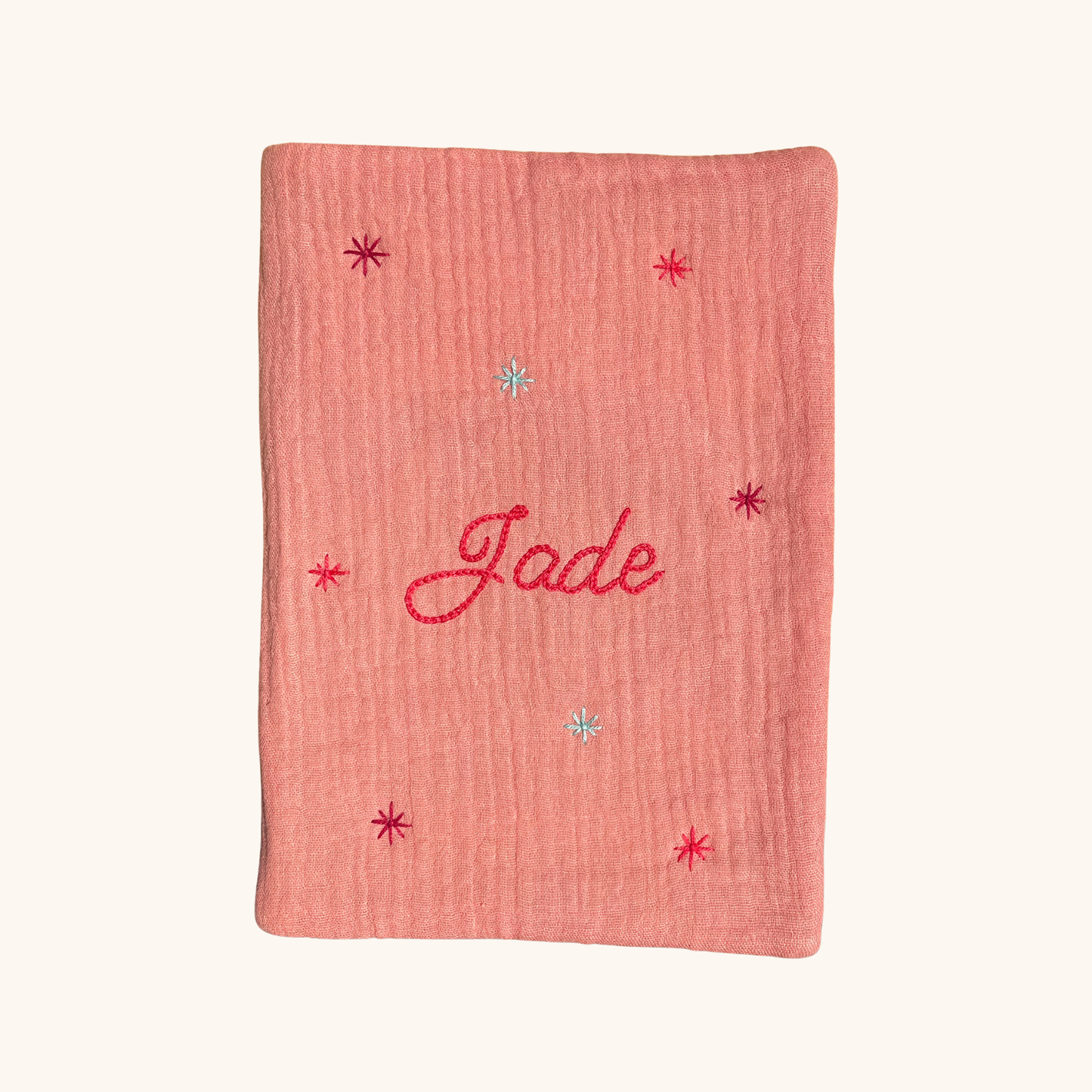 Protège carnet de santé personnalisé rose poudré, brodé à la main au prénom de l’enfant avec des étoiles délicates – création artisanale Savane Paris en gaze de coton, édition limitée.